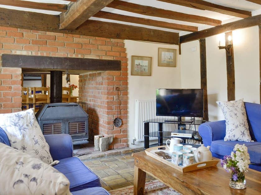 Welcoming living room with exposed wood beams | Meadow Cottage, Linstead Parva, near Southwold