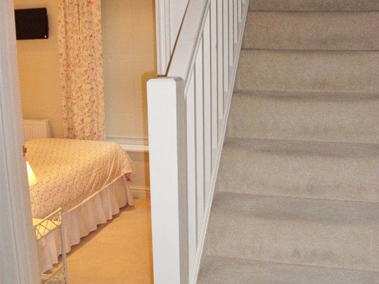 Stairs lead down to all the bedrooms and family bathroom | Watch House, Fowey