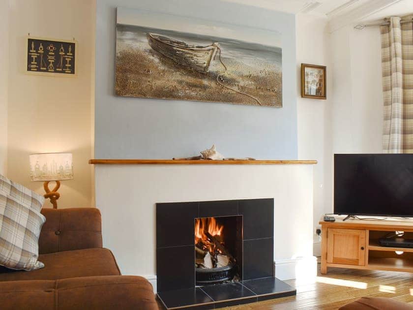 Charming living room with an open fire | Compass Point, Brixham