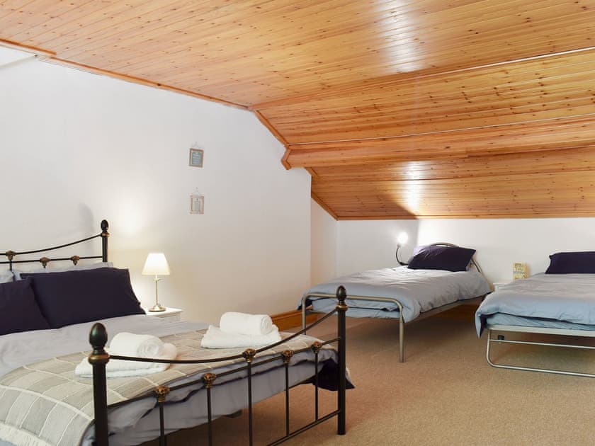 Bedroom with double bed and an additional two single beds | Compass Point, Brixham