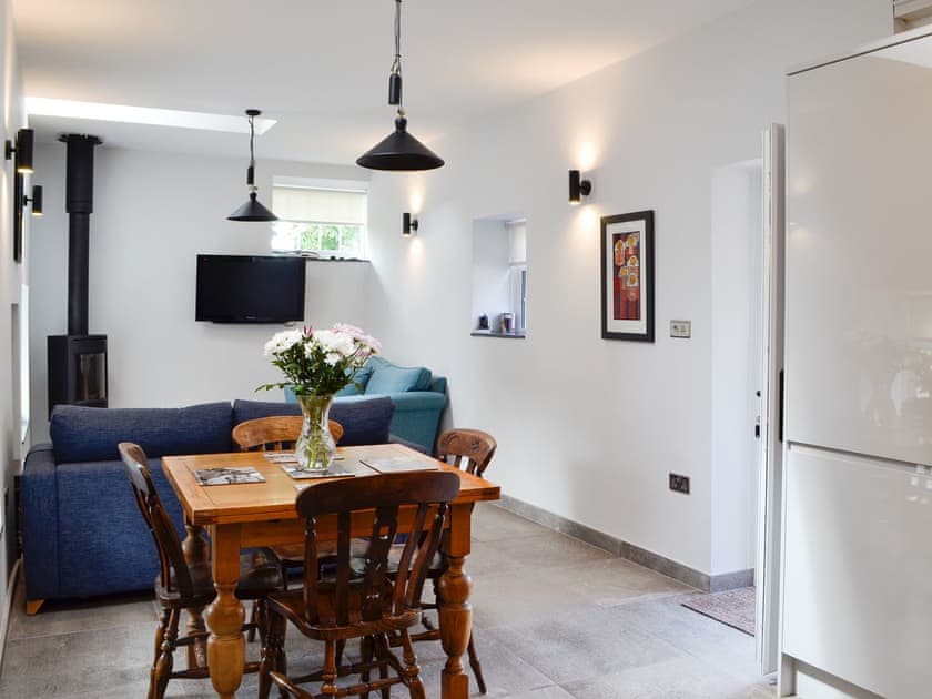 Living area with dining table and chairs | Bwythn Y Saer, Plas Cilybebyll, near Pontardawe