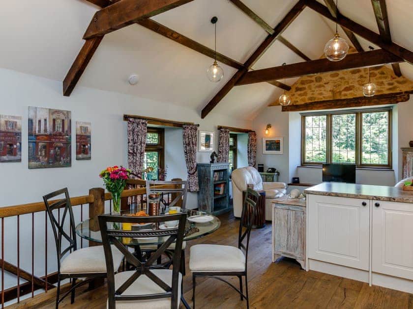 Exposed wooden beams throughout the living area | Stable Cottage, Uley, near Dursley