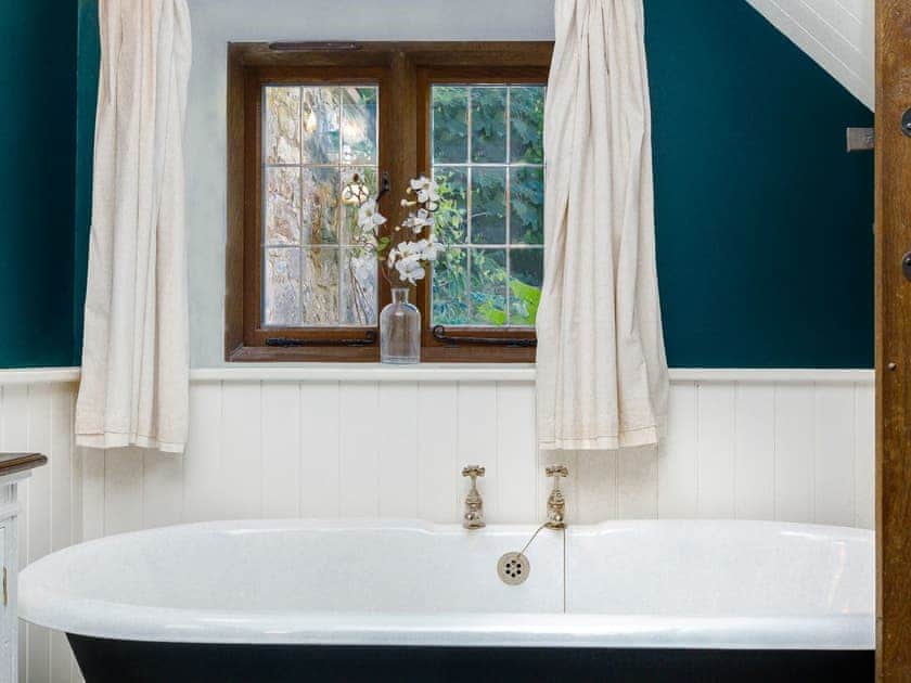 Free-standing roll-top bath within bathroom | Stable Cottage, Uley, near Dursley