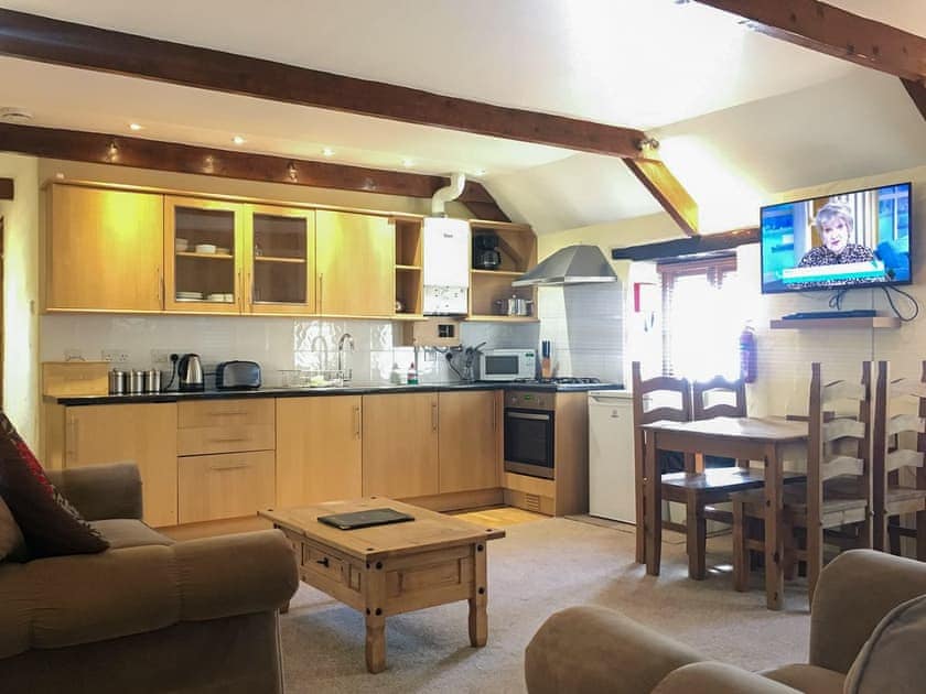 Open plan living space with beams throughout | Porth Cottage - Carnebo Farm, Goonhavern, near Newquay