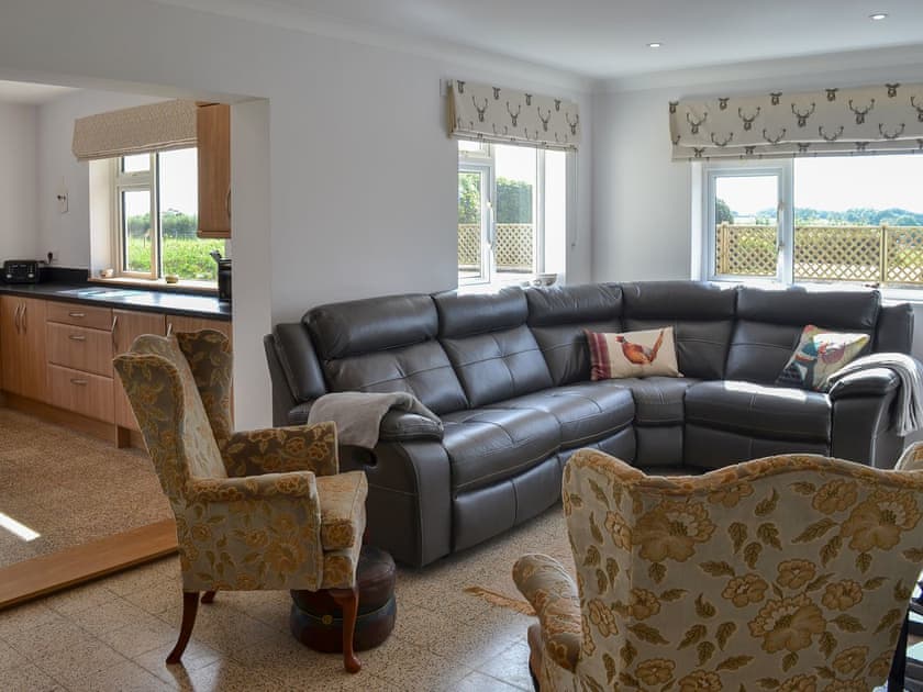 Leather sofa and wing-backed armchairs in the living room | West Middlewick Farm - The Old Creamery - West Middlewick Farm , Nomansland, near Tiverton