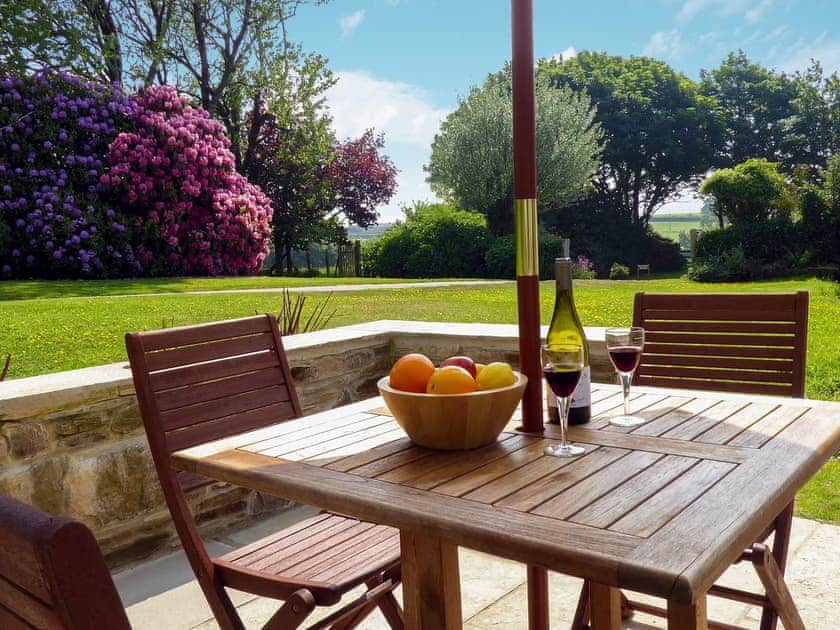 Patio with garden furniture and barbecue | The Linney - Cartole Cottages, Pelynt, near Looe