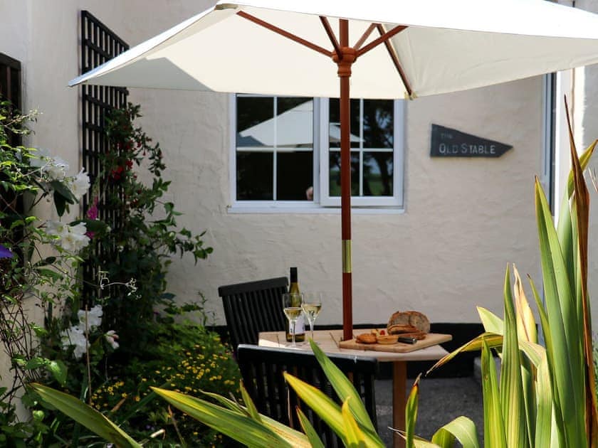 Patio with garden furniture and barbecue | The Old Stable - Cartole Cottages, Pelynt, near Looe