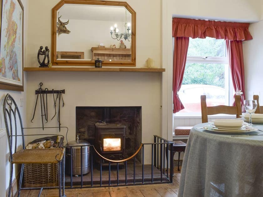 Warming wood burner within dining area | Hill View House - Hillview Holidays, Aberfeldy