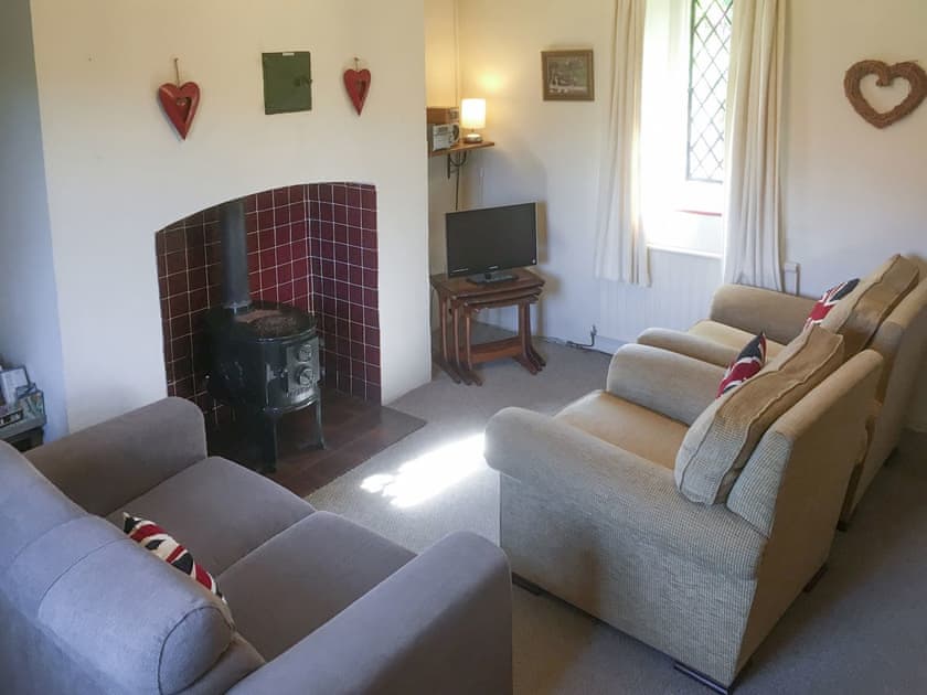 Cosy snug with log burner and DVD player | Park House, Harlaxton, near Grantham