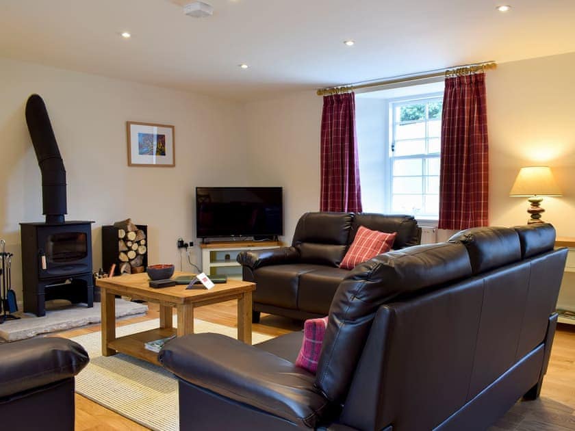 Comfortable living room with wood burner | Brandoch Lodge - Kinnaird Estate Cottages, By Dunkeld