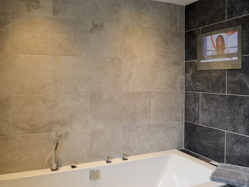 Bathroom with wall mounted TV | Apple Tree House, Dalry