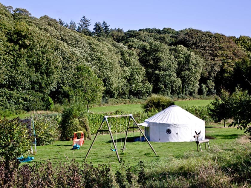 Play field with yurt and play equipment for children | Greenwood Grange Cottages, Higher Bockhampton, near Dorchester