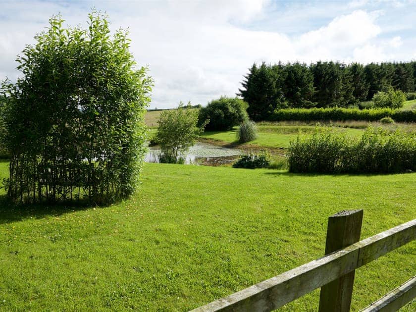 Secluded romantic bench seating besides the lake | Greenwood Grange Cottages, Higher Bockhampton, near Dorchester