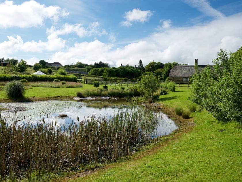 Beautiful grounds including a picturesque lake | Greenwood Grange Cottages, Higher Bockhampton, near Dorchester