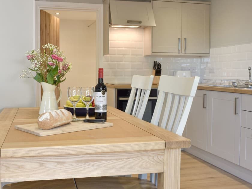 Fully equipped kitchen with dining area within the open-plan design | Threagill Cottage - Boon Town Farm, Warton, near Carnforth