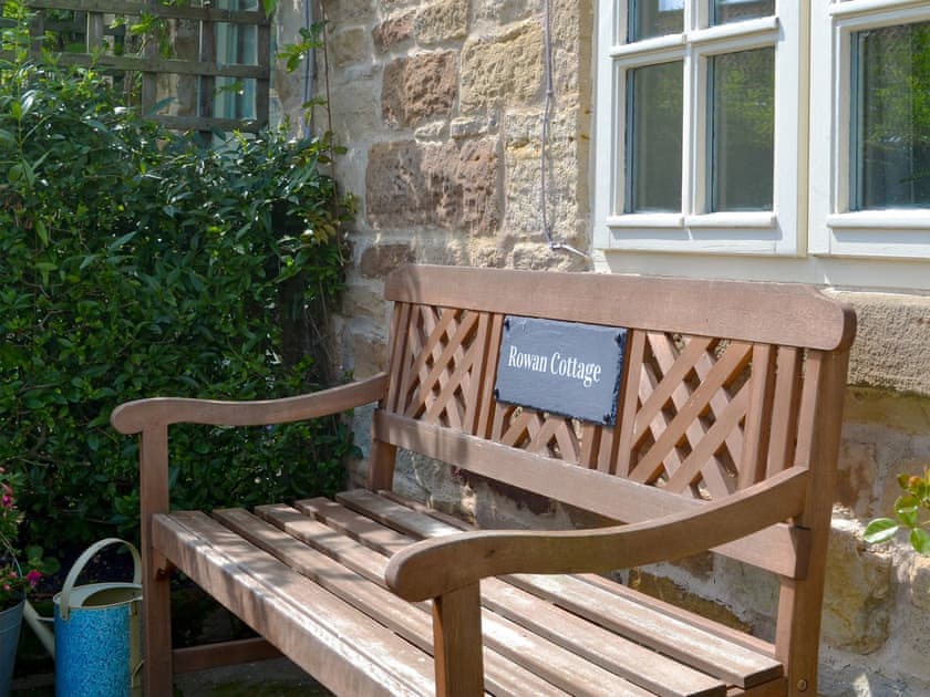 Relax and admire the garden from the front bench | Rowan Cottage, Aislaby, near Whitby