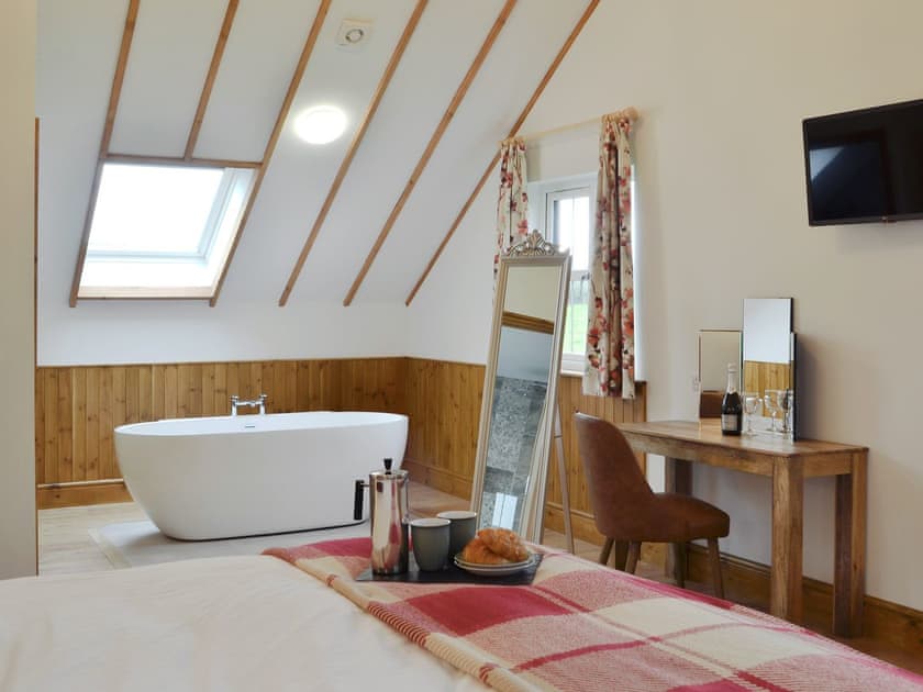 Free-standing bath within second double bedroom | Lakeside Lodge, near Rhayader