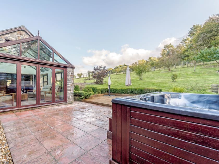 Patio with garden furniture and private hot tub | Rhiew Banc, Bwlch-y-ffridd, near Newtown