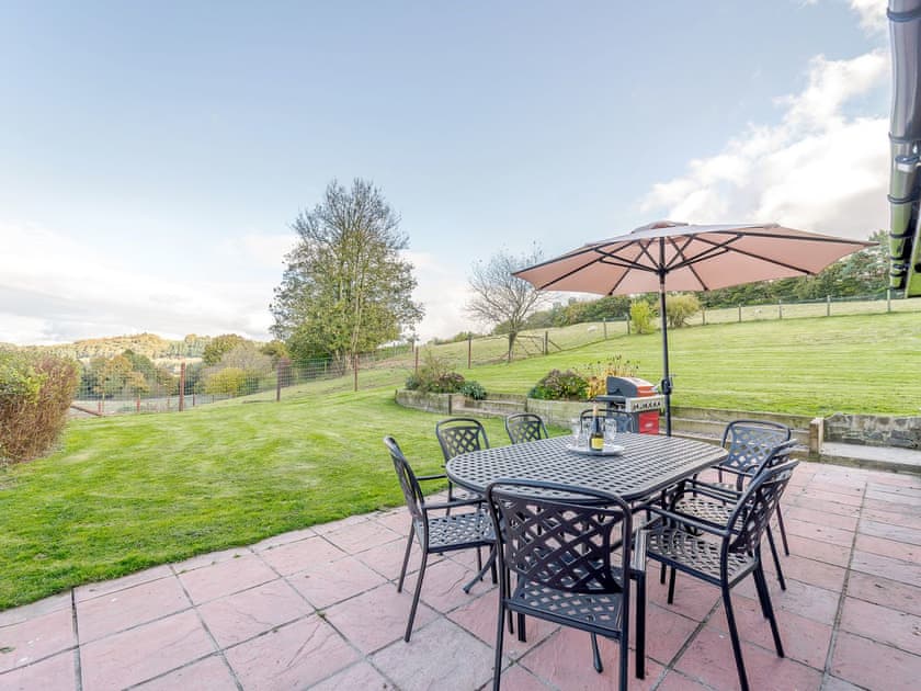 Enclosed lawned garden with patio, garden furniture and BBQ | Rhiew Banc, Bwlch-y-ffridd, near Newtown
