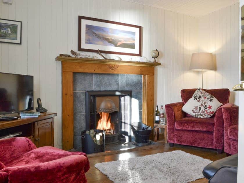 Welcoming living room with open fire | Shore Cottage, Arnisdale, near Glenelg