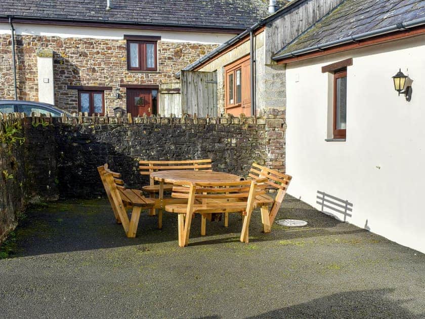 Private courtyard with garden furniture | Trewin Court - Well Farm Holiday Cottages, Holsworthy, near Launceston