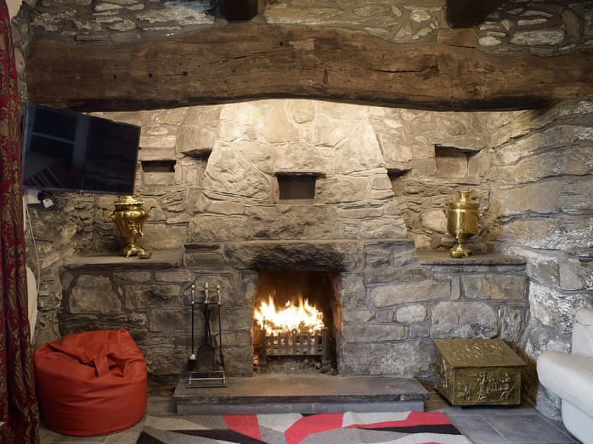 Outstanding stone fireplace within the living room | Groudd Hall Cottage, Cerrigydrudion, near Betws-y-Coed
