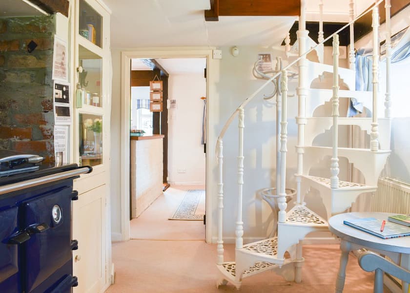 Secondary kitchen area with Aga and spiral staircase | Yew Tree Cottage, Farnham, near Blandford Forum