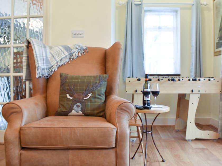 Leather armchair and table football in the living room | The Cottage by the Sea - The Cottages by the Sea, Littlehampton, near Arundel