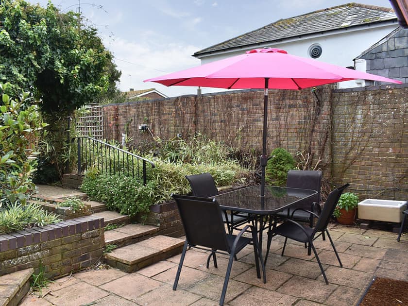 Paved patio area with steps up to the garden | The Cottage by the Sea - The Cottages by the Sea, Littlehampton, near Arundel