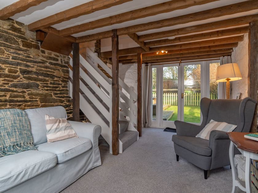Characterful living area with French doors to garden | Dairy Cottage, Fowey