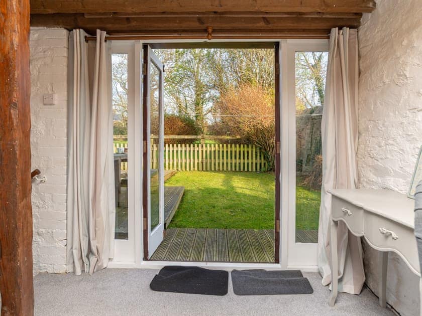 French doors to garden from living room | Dairy Cottage, Fowey