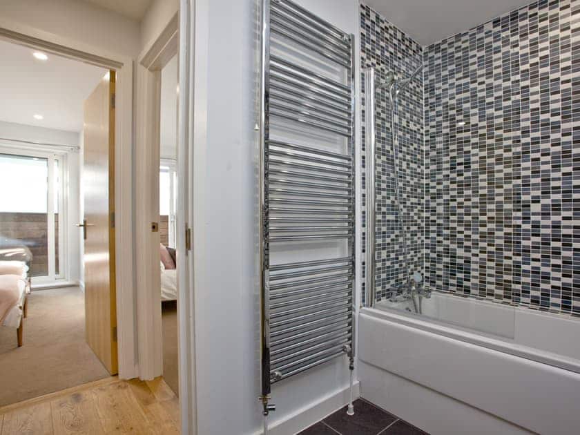 Family bathroom with shower over bath | Apartment 25, Newquay
