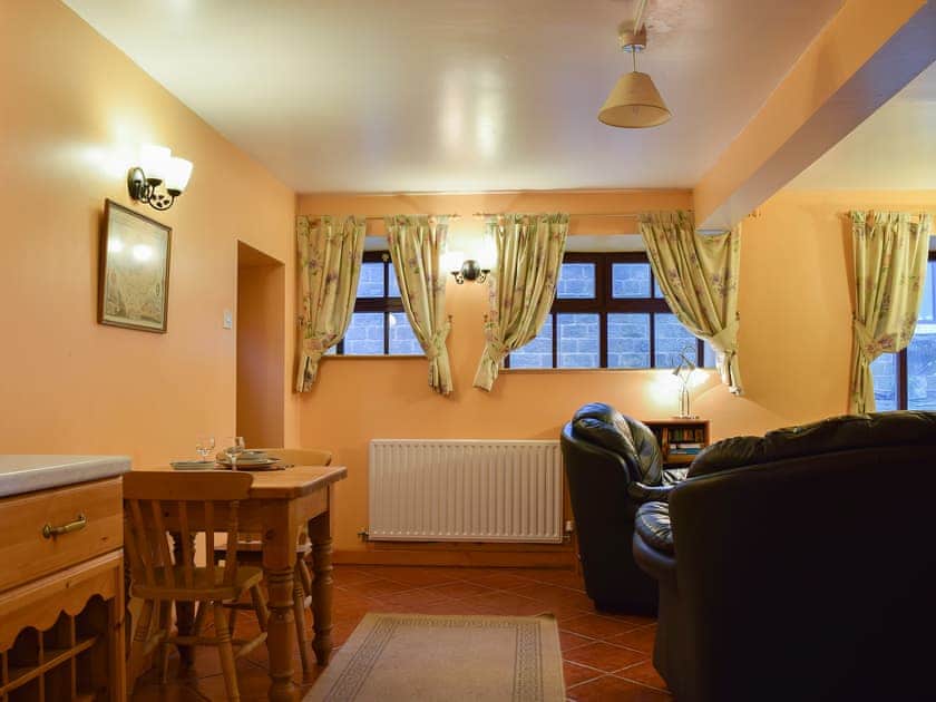 Intimate dining area and adjacent living room | The Stables - Harvey Gate Farm, Onecote