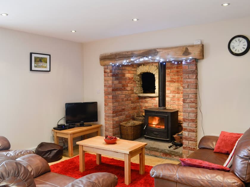 Cosy living room with feature fireplace | Llandremor Fawr Cottage, near Pontarddulais