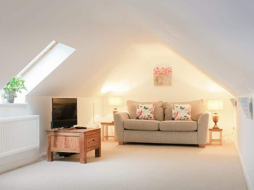Additional cozy seating area with Freeview TV and sofa bed | Maple Lodge, Corsham