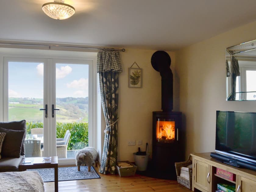 Comfortable living room with wood burning stove | The Barn, Gwyddelwern near Corwen