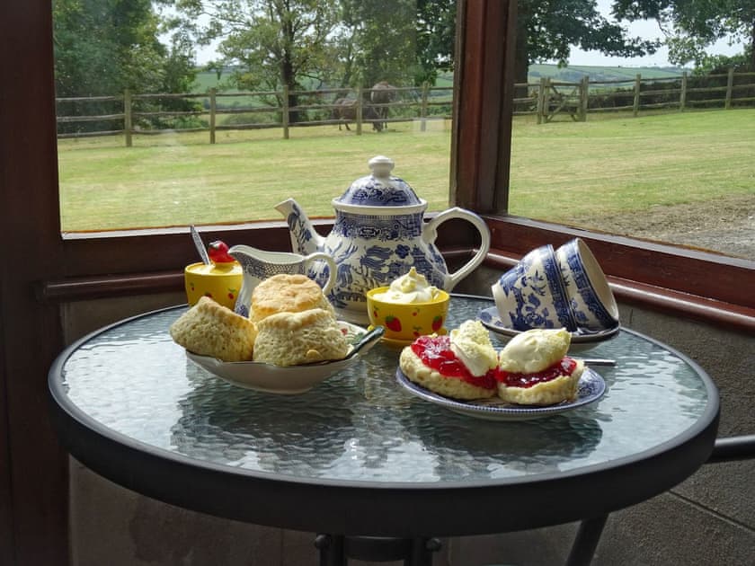 Porch overlooking garden | Penfound Country Cottage, Poundstock, near Bude