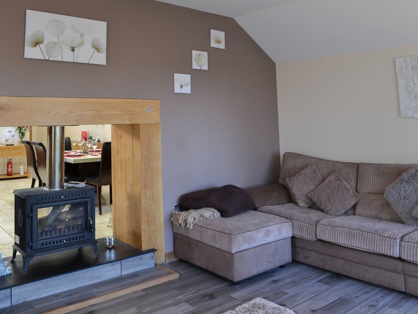 Cosy and comfortable living room with dual aspect wood burner | Heckley Stable Cottage - Heckley Cottages, Alnwick