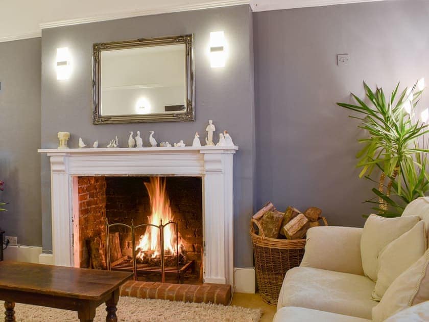 Warm and cosy living room with an open fire | Leygreen Farmhouse, Beaulieu, near Brockenhurst