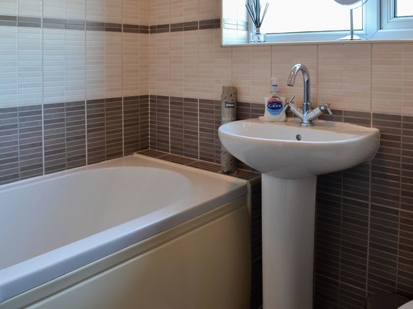 Bathroom with shower over the bath | Squirrel Cottage, Seamer, near Scarborough