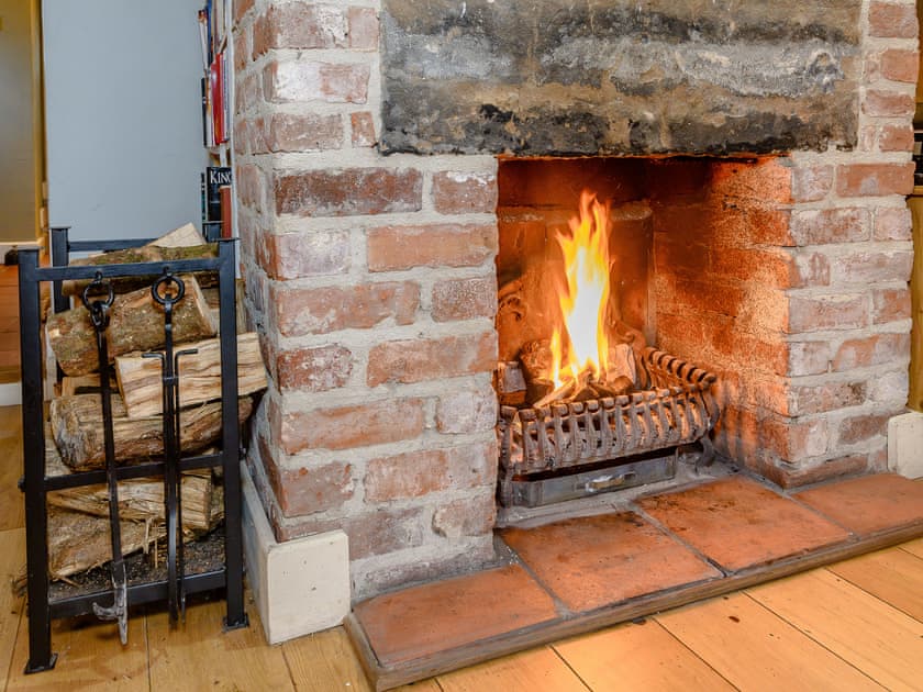 Welcoming living room with open fire | The Smithy, Brassington, near Matlock