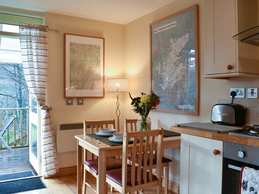 Dining area next to the balcony doors | River Cottage - Milton, Drumnadrochit, near Inverness