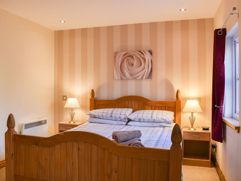 Welcoming bedroom with pine bed | River Cottage - Milton, Drumnadrochit, near Inverness