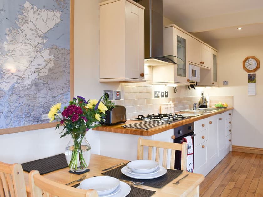 Dining and adjacent kitchen area | River Cottage - Milton, Drumnadrochit, near Inverness