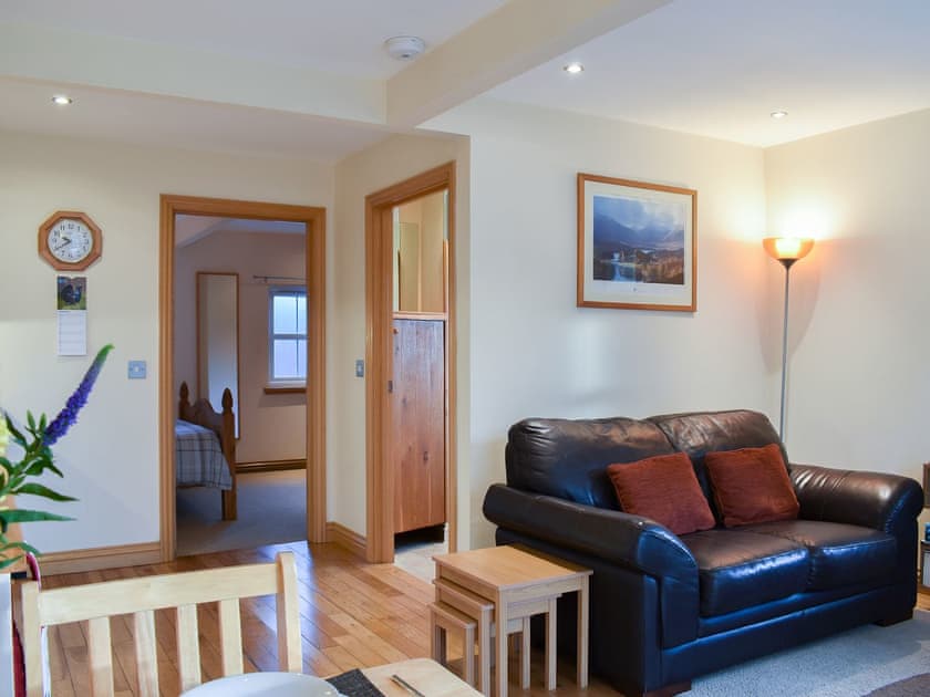 Open plan living area through to the bedroom | River Cottage - Milton, Drumnadrochit, near Inverness