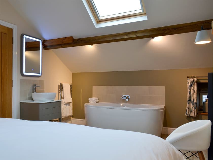 Relaxing roll-top bath in the bedroom | The Hayloft - Branthwaite Cottages, Branthwaite, near Caldbeck