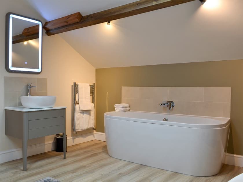 Relaxing roll-top bath in the bedroom | The Hayloft - Branthwaite Cottages, Branthwaite, near Caldbeck