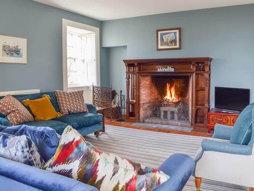 Welcoming living room with open fire | The Barracks @ East Neuk Orchards - Self Catering @ East Neuk Orchards, Pittenweem, near Anstruther