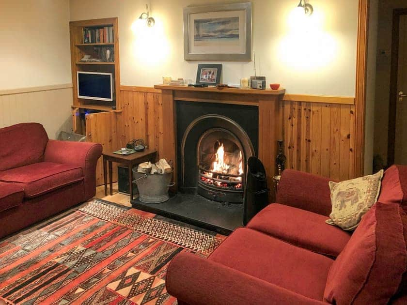 Cosy living room with an open fire | Crofts, Glenbuchat