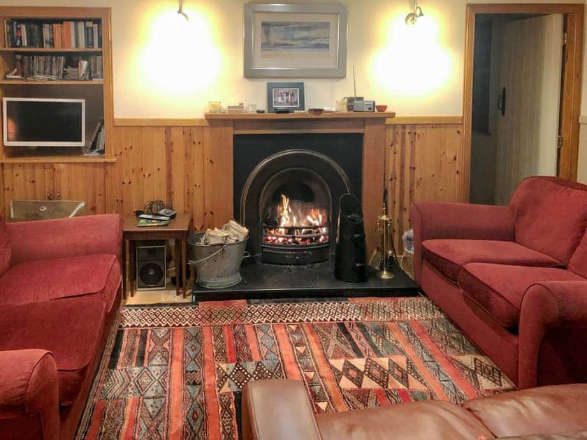 Cosy living room with an open fire | Crofts, Glenbuchat